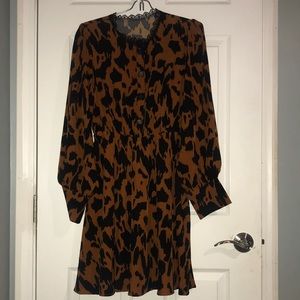 rust colored long sleeve flowy dress with black lace neck detailing